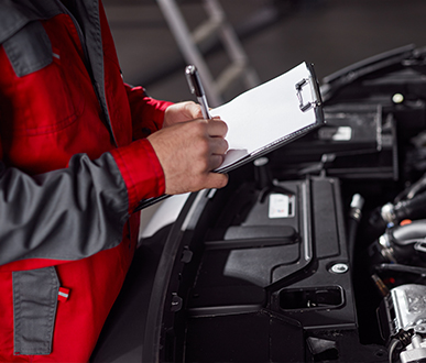 mechanic making notes clipboard near 1