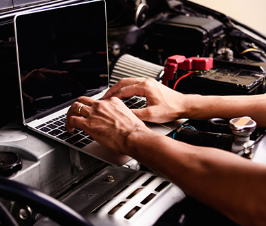 professional car repair maintenance mechanic engine working service with laptop computer