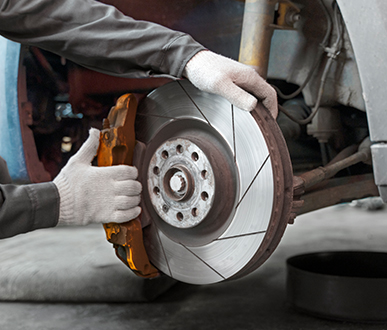 side view worker repairing car